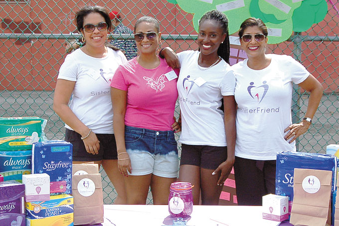 WOMEN'S NEEDS—The SisterFriend Inc. team, from left: Shauna Brown, Julie Strickland-Gillard, founder Tamara Whiting and Darlene Powell, with its SisterFriend kits and other feminine hygiene products collected at its Community Outreach Day. (Photo by Rossano P. Stewart)