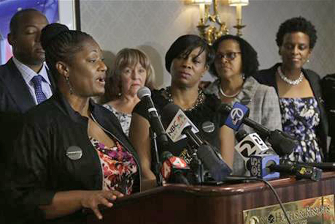 Tira McDonald, left, one of the plaintiffs filing a lawsuit over their ejection from a Napa Valley Wine Train, speaks at a news conference, Thursday, Oct. 1, 2015, in San Francisco. Also pictured are attorney Waukeen Q. McCoy, from left rear, and plaintiffs Linda Carlson, Lisa Johnson, Sandra Jamerson and Allisa Carr. A group of mostly black women who were ejected from a Northern California wine country train this summer say they felt humiliated and can't believe they were treated that way in 2015. (AP Photo/Jeff Chiu)