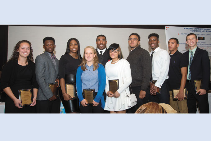 FUTURE HALL OF FAMERS—Pittsburgh area native, and Steelers Super Bowl champion Mike Logan, center, presents the Pittsburgh City League Junior Hall of Fame awards to the current City League outstanding student athletes. All of whom are tops in their class. (Photos by Gail Manker) 