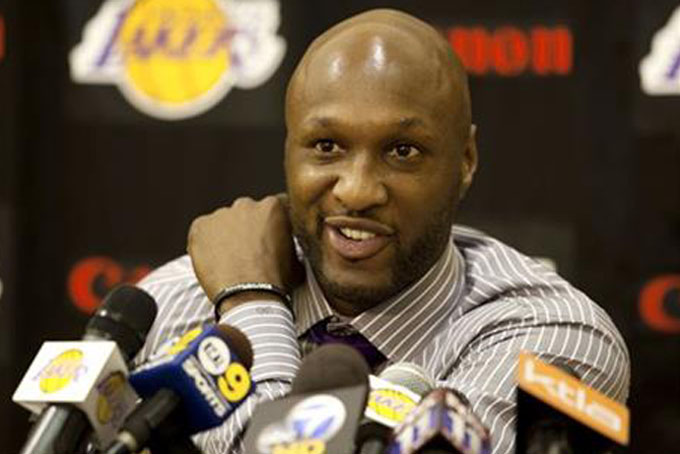 FILE - In this July 31, 2009, file photo, Los Angeles Lakers' Lamar Odom speaks to the media during a news conference after the Lakers signed Odom to a multi-year NBA basketball contract, in El Segundo, Calif. Odom spent most of his 14-year NBA career in Los Angeles with the Lakers and Clippers, becoming a fan favorite before he sought even more fame with the Kardashians. Odom, who was embraced by teammates and television fans alike for his Everyman approach to fame, was found face-down and alone Tuesday, Oct. 13, 2015, after spending four days at the Love Ranch, a legal Nevada brothel. (AP Photo/Jeff Lewis, File)
