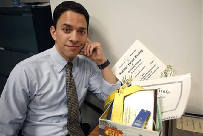 In this Wednesday, Nov. 4, 2015 photo, psychologist Tim Bono poses for a photo with childhood ribbons and awards in his office at Washington University in St. Louis. A while back, Bono, 32, discovered the relics from his past that reinforced what he and so many in his generation were told, that they were special and could do anything they set their mind to. "My generation has been bathed in messages of how great we are and how anything is possible for us," Bono says, noting that that mindset can easily lead to disappointment. (AP Photo/Jeff Roberson)