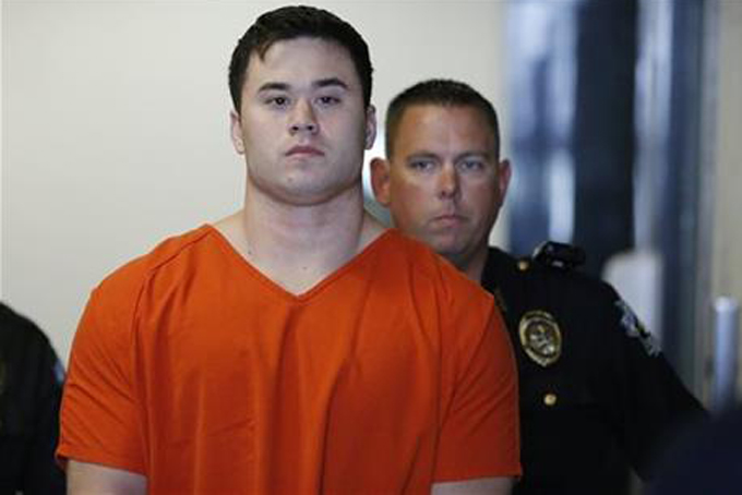 In this Sept. 3, 2014 file photo, Daniel Holtzclaw, foreground, a former Oklahoma City police officer accused of sexual offenses against 13 women he encountered while on patrol, is led into a courtroom for a hearing in Oklahoma City. Holtzclaw's trial is scheduled to begin on Monday, Nov. 2. (AP Photo/Sue Ogrocki, File)