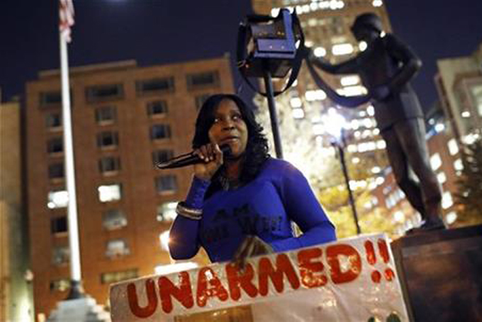 In this Oct. 21, 2015 picture, Tawanda Jones leads a vigil for her brother, Tyrone West, outside of Baltimore City Hall.  (AP Photo/Patrick Semansky)