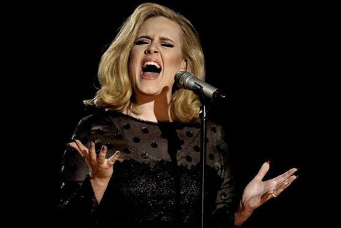 FILE - In this Feb. 12, 2012 file photo, Adele performs during the 54th annual Grammy Awards in Los Angeles. The singer’s hotly anticipated new album, "25," is out Friday, Nov. 20, 2015. (AP Photo/Matt Sayles, File)