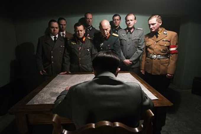 This photo provided by the Smithsonian Channel shows, an actor portraying Adolf Hitler, seated, addressing his top generals in the new Smithsonian Channel special, “The Day Hitler Died." The documentary premieres on the Smithsonian Channel on Monday, Nov. 16, 2015, at 8 p.m. EDT/PDT. (Smithsonian Channel via AP)