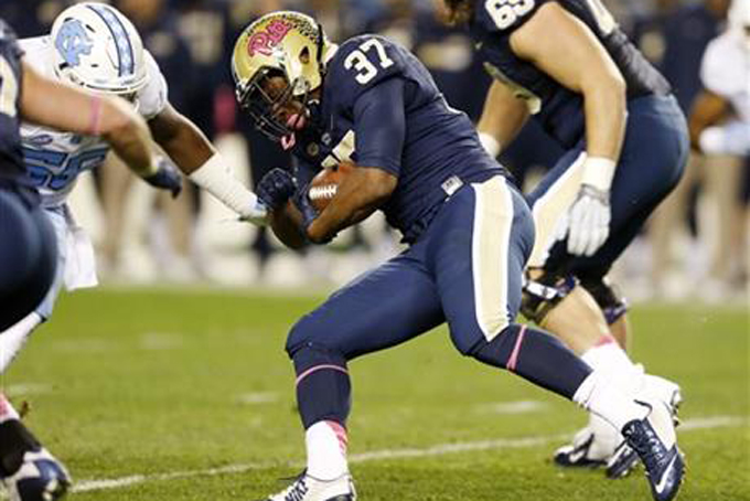 Pittsburgh running back Qadree Ollison (37) runs the ball towards North Carolina linebacker Andre Smith (56) in the first quarter of an NCAA college football game, Thursday, Oct. 29, 2015, in Pittsburgh. (AP Photo/Keith Srakocic)