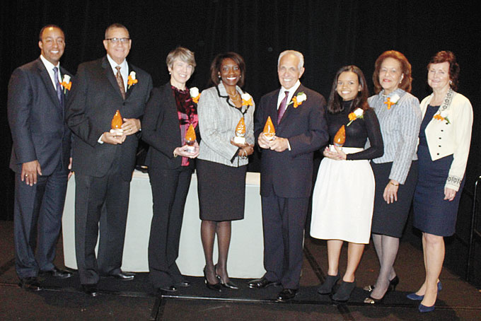 PITTSBURGH LEADERS HONORED—From left: Emcee Evan Frazier, honoree Gregg Spencer; Susan Friedberg Kalson of the Squirrel Hill Health Center; honoree Tracy McCants Lewis; honoree Joseph Lagana; honoree Kendal Nasiadka; YWCA Board President Marsha Jones; and YWCA CEO Magdeline Jensen. (Photo by J.L. Martello) 