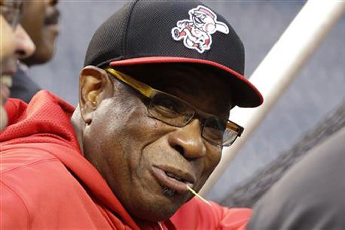 In this Sept. 30, 2013 file photo, then-Cincinnati Reds manager Dusty Baker talks with visitors behind the batting cage during the baseball team's workout in Pittsburgh. (AP Photo/Gene J. Puskar, File)