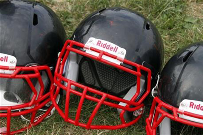 In this Aug. 4, 2012, file photo, Riddell football helmets that were given to a group of youth football players from the Akron Parents Pee Wee Football League are shown in Akron, Ohio. (AP Photo/Gene J. Puskar, File)