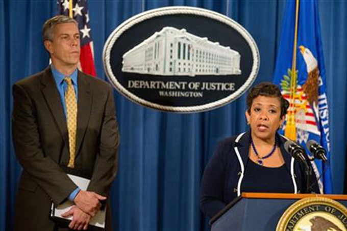 Attorney General Loretta Lynch, accompanied by Education Secretary Arne Duncan, speaks at a news conference at the Justice Department in Washington, Monday, Nov. 16, 2015, to announce a major federal and state civil litigation settlement concerning Educational Management Corp., a Pittsburgh-based company that runs for-profit trade schools. (AP Photo/Andrew Harnik)