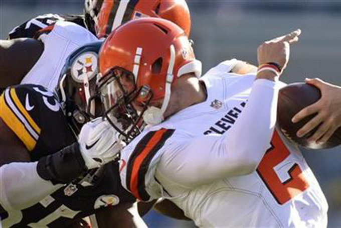 Cleveland Browns quarterback Johnny Manziel (2) is tackled by the face mask by Pittsburgh Steelers outside linebacker Arthur Moats (55) in the second quarter of an NFL football game, Sunday, Nov. 15, 2015, in Pittsburgh. Moats was penalized on the play. (AP Photo/Don Wright)