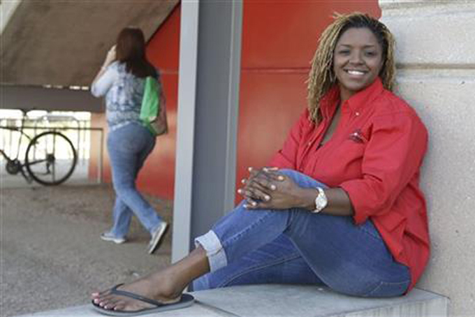 In this Oct. 5, 2015, file photo, Roni Dean-Burren poses on the campus of the University oh Houston, in Houston. Dean-Burren asked publisher McGraw-Hill Education to change the text in a geography book that refers to slaves as "workers." (AP Photo/Pat Sullivan, File)