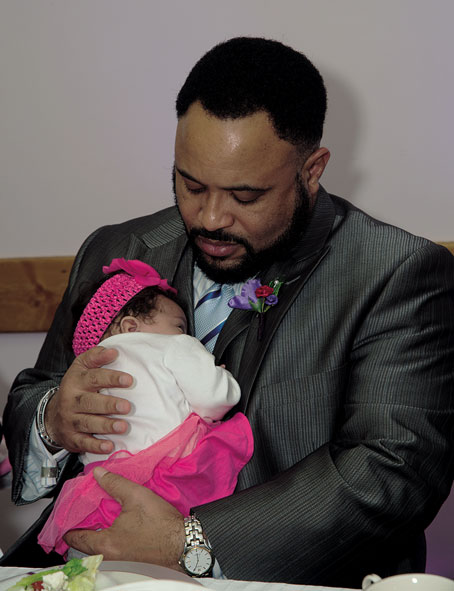 REV. CAMPBELL WITH YOUNGEST MEMBER OF THE FAMILY