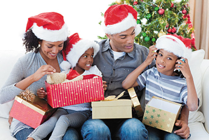 OPENING CHRISTMAS GIFTS—A family opening Christmas presents together. There are thousands of people who see the time spent with family as being the greatest gift. (Stock image )