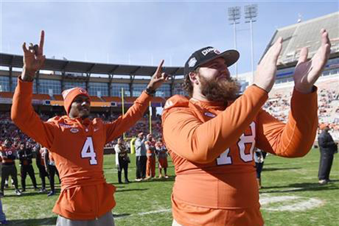 Clemson football quarterback Deshaun Watson, left, and offensive guard Eric Mac Lain celebrate during a pizza party celebrating Selection Sunday at Memorial Stadium, Sunday, Dec. 6, 2015, in Clemson, S.C. (AP Photo/Rainier Ehrhardt)