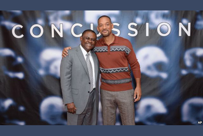  In this Dec. 14, 2015, file photo, Dr. Bennet Omalu, left, and actor Will Smith pose together at the cast photo call for the film "Concussion" at The Crosby Street Hotel in New York. The movie releases in U.S. theaters on Dec. 25, 2015. 