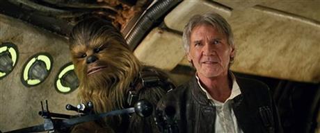 This photo provided by Lucasfilm shows Peter Mayhew as Chewbacca and Harrison Ford as Han Solo in "Star Wars: The Force Awakens," directed by J.J. Abrams. Lawrence Kasdan co-wrote the screenplay with Abrams. (Film Frame/Lucasfilm via AP) -