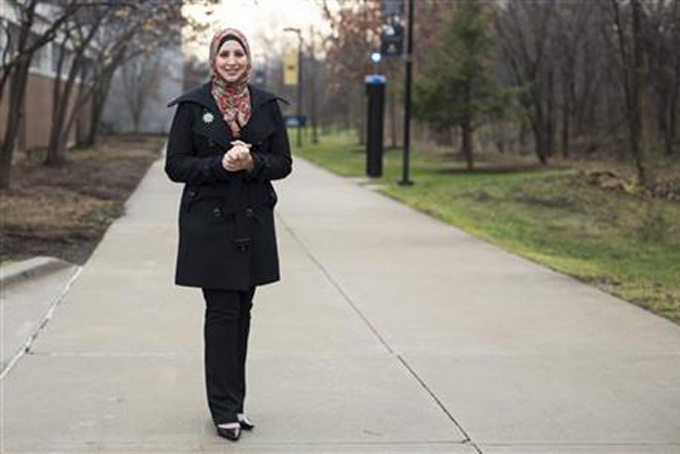 Suehaila Amen, coordinator of International Admissions and Recruitment at the University of Michigan Dearborn, is seen on campus, Thursday, Dec. 10, 2015 in Dearborn, Mich. Amid the high level of harassment, threats and vandalism directed at American Muslims and at mosques, Muslim women are intensely debating the duty and risks related to wearing their head-coverings as usual. (AP Photo/Tim Galloway)
