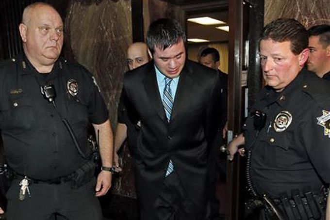 Former Oklahoma City police officer Daniel Holtzclaw, center, cries as he is led from the courtroom after the verdicts were read for the charges against him at the Oklahoma County Courthouse in Oklahoma City, Thursday, Dec. 10, 2015. Holtzclaw was convicted of raping and sexually victimizing eight women on his police beat in a minority, low-income neighborhood. (Nate Billings/The Oklahoman via AP)