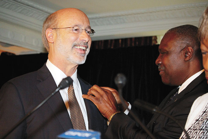 HONORARY MEMBER—Pennsylvania Gov. Tom Wolf smiles as African American Chamber of Commerce Board Chair Samuel Stephenson places a chamber pin on his lapel. 