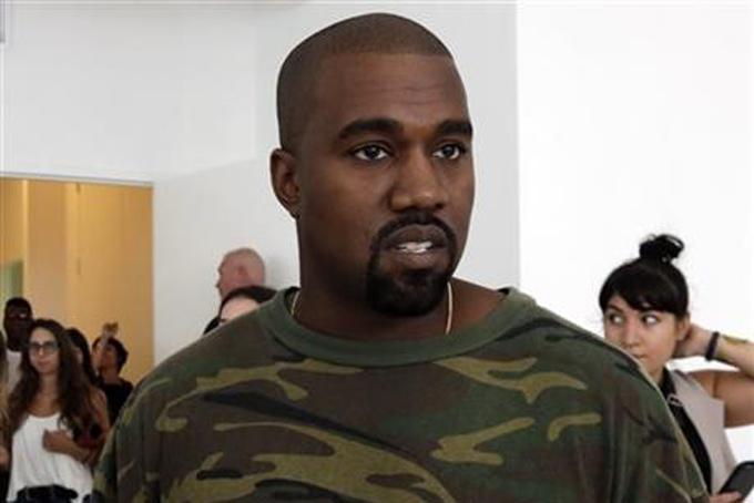 FILE - In this Sept. 10, 2015 file photo, Kanye West appears at the Brother Vellies Spring 2016 collection presentation during Fashion Week, in New York. West's Adidas Yeezy Boost was honored as shoe of the year at the Footwear News Achievement Awards on Wednesday, Dec. 2, in New York. (AP Photo/Richard Drew, File)