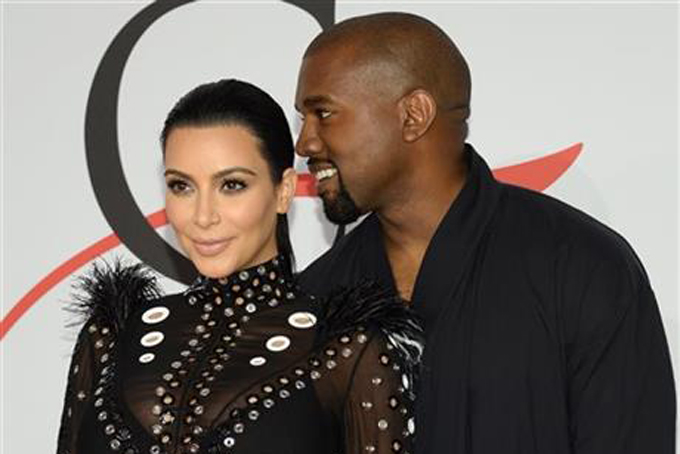 In this Monday, June 1, 2015, file photo, Kim Kardashian, left, and Kanye West arrive at the 2015 CFDA Fashion Awards at Alice Tully Hall, Lincoln Center, in New York. (Photo by Evan Agostini/Invision/AP, File)