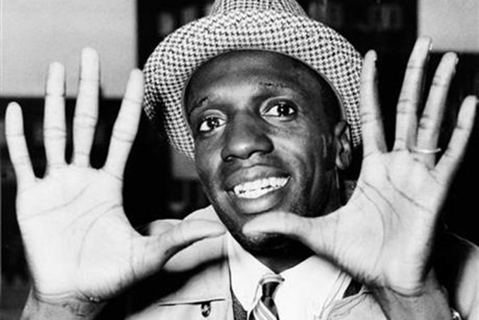 In this May 17, 1959, file photo, Meadowlark Lemon, of the Harlem Globetrotters, shows off his large hands on arrival in London where the team was to perform at the Empire Pool in Wembley for a week. (AP Photo/File)