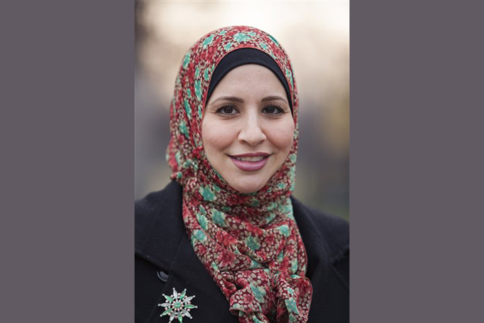 Suehaila Amen, coordinator of International Admissions and Recruitment at the University of Michigan Dearborn is seen on campus, Thursday, Dec. 10, 2015 in Dearborn, Mich. Amid the high level of harassment, threats and vandalism directed at American Muslims and at mosques, Muslim women are intensely debating the duty and risks related to wearing their head-coverings as usual. (AP Photo/Tim Galloway)