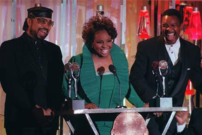 FILE- In this Jan. 17, 1996, file photo, Gladys Knight, center, William Guest, left, and Merald Knight take the stage as they are inducted into the Rock and Roll Hall of Fame during ceremonies in New York. William Guest, a member of Gladys Knight and the Pips, has died. He was 74. Guest's daughter, Monique Guest, said her father died Thursday, Dec. 24, 2015. (AP Photo/Mark Lennihan, File)