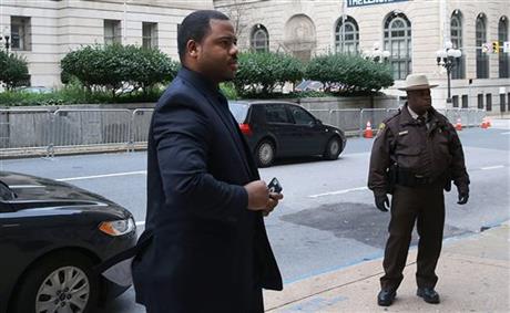 William Porter, left, one of six Baltimore city police officers charged in connection to the death of Freddie Gray, arrives at a courthouse as jury deliberations continue in his trial, Wednesday, Dec. 16, 2015, in Baltimore. Porter faces charges of manslaughter, assault, reckless endangerment and misconduct in office. (Mark Wilson/Pool Photo via AP)