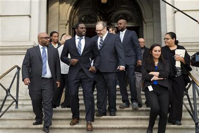 Pittsburgh Steelers quarterback Mike Vick, center left, departs after a news conference, Tuesday, Dec. 8, 2015, at the state Capitol in Harrisburg, Pa. (AP Photo/Matt Rourke)