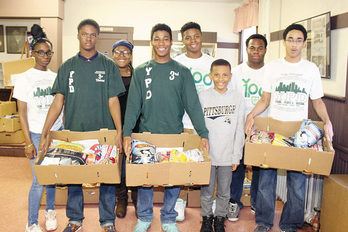 YOUTH GIVING THEIR SUPPORT—From left: Youths Kadiah Harris, Malik Wells, Dejah Hill, Jymoni Rainey, Reggie Holt, Jay Walker, Cameron Rainey and Brandon Harris are just a few of the individuals that came from several communities and churches to help distribute the many boxes of food to those in need.