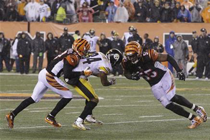Cincinnati Bengals' Vontaze Burfict (55) runs into Pittsburgh Steelers' Antonio Brown (84) during the second half of an NFL wild-card playoff football game Sunday, Jan. 10, 2016, in Cincinnati. Pittsburgh won 18-16. Burfict was called for a penalty on the play. (AP Photo/John Minchillo)