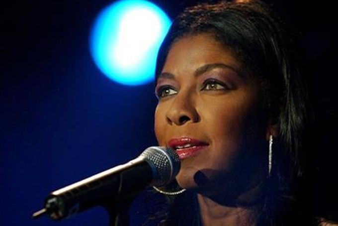 FILE - In a Sunday, July 6, 2003 file photo, singer Natalie Cole performs on Stravinsky stage, during the 37th Montreux Jazz Festival, in Montreux, Switzerland. Cole, the daughter of jazz legend Nat "King" Cole who carried on his musical legacy, died Thursday night, Dec. 31, 2015, according to publicist Maureen O'Connor. She was 65. (AP Photo/ Keystone, Martial Trezzini, File)
