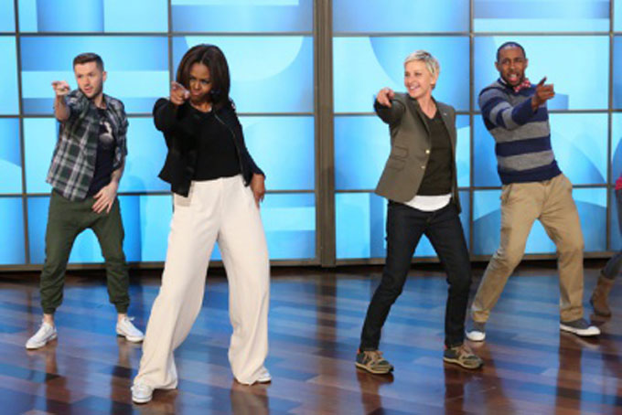 GIMME FIVE—Talk show host Ellen DeGeneres dances with First Lady Michelle Obama’s as she takes part in Obama’s #GimmeFive Challenge in honor of the 5th Anniversary of “Let’s Move!” Initiative, March 12, 2015 at the Warner Bros. lot in Burbank, Calif. (AP Photo/Warner Bros., Mike Rozman) 