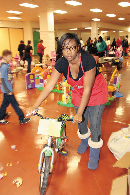 GIVING AND RECEIVING—This young woman not only selected gifts for her family, but also gave back by volunteering.