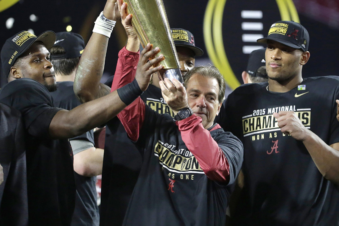 Alabama head coach Nick Saban, center, holds up the championship trophy with players after the NCAA college football playoff championship game against Clemson Monday, Jan. 11, 2016, in Glendale, Ariz. Alabama won 45-40. (AP Photo/Chris Carlson)  