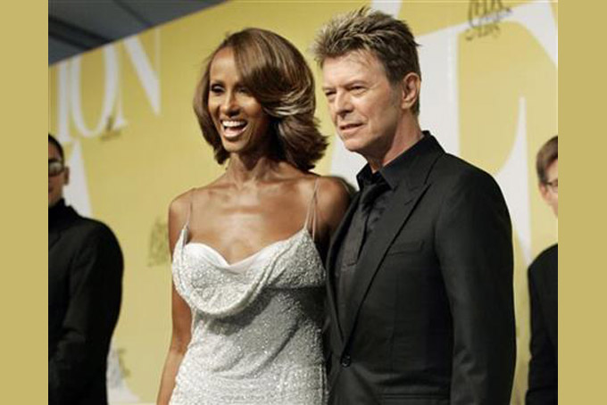 FILE - In this June 6, 2005 file photo, singer David Bowie and his wife Iman pose at the 2005 CFDA Fashion Awards in New York. Bowie, the innovative and iconic singer whose illustrious career lasted five decades, died Monday, Jan. 11, 2015, after battling cancer for 18 months. He was 69 (AP Photo/Stuart Ramson, File)