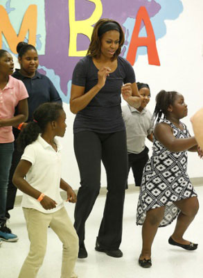 ZUMBA SESSION—First Lady Michelle Obama participates in zumba session at a Miami parks and recreation center during a visit to promote her “Let’s Move” campaign Feb. 25, 2014. (AP Photo/Joel Auerbach)