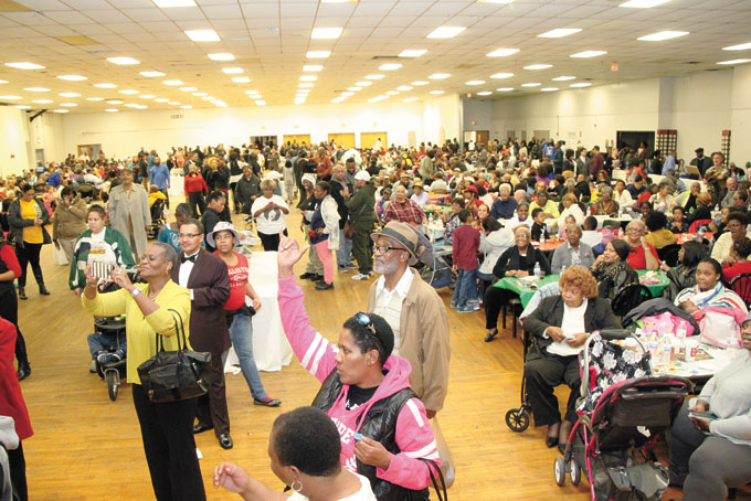 NOTHING LIKE A CHRISTMAS PARTY—State Rep. Ed Gainey understands the meaning to the question, “What’s Christmas without a party?” Last month, Gainey held his annual colossal neighborhood Christmas celebration for citizens living in his district, Homewood and the surrounding East End area, at the Greater Pittsburgh Coliseum. His goal, which was to say “thanks to the community for their support as well as inspire neighborhood pride,” was achieved with catered soul food, music provided by DJ Louie Bates and many giveaways. There were raffles, toys and gift certificates that were all donated by local businesses, corporations, and churches, and added to the success of the event. (Photos /copy by Jackie McDonald) 
