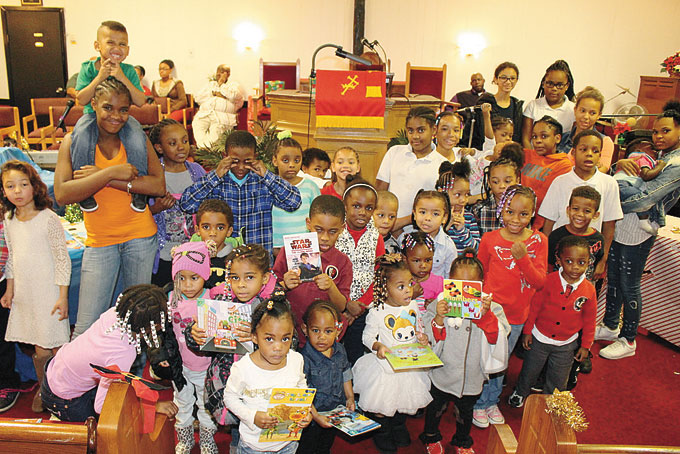 PARTY AND GIFTS—Narrow Way International Ministries COGIC, located at 615 Taft Ave., in Mt. Oliver, hosted its Annual Christmas Party. The event included local artists singing gospel Christmas classics and much more. Also, toys and gifts were passed out to families in the community. Pictured above are all the kids who received new toys at the event. (Photos by J. L. Martello)