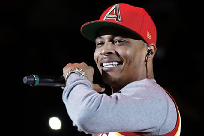 In this Nov. 1, 2014, file photo, rapper T.I. performs before the start of an NBA basketball game between the Indiana Pacers and the Atlanta Hawks in Atlanta. The Hawks are collaborating with big-name hip-hop artists like T.I., Ludacris and Big Boi in what the team calls an effort to make amends after it was revealed two officials made racially charged remarks in separate incidents. (AP Photo/David Goldman, File)