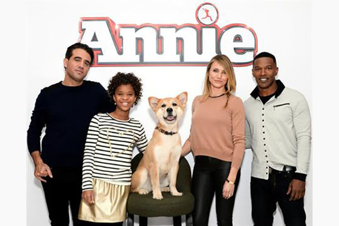 FILE - In this Dec. 4, 2014 file photo, the cast of "Annie" from left, Bobby Cannavale, Quvenzhane Wallis, Marty the dog, Cameron Diaz and Jamie Foxx poses during a photo call in New York. Movies make more money when exactly half the cast is non-white, according an annual analysis released Thursday, Feb. 25, 2016, that shows an even stronger connection between diversity and profits, and suggests how profoundly out of touch the motion picture academy is when giving Oscars only to white actors. (Photo by Evan Agostini/Invision/AP, File)