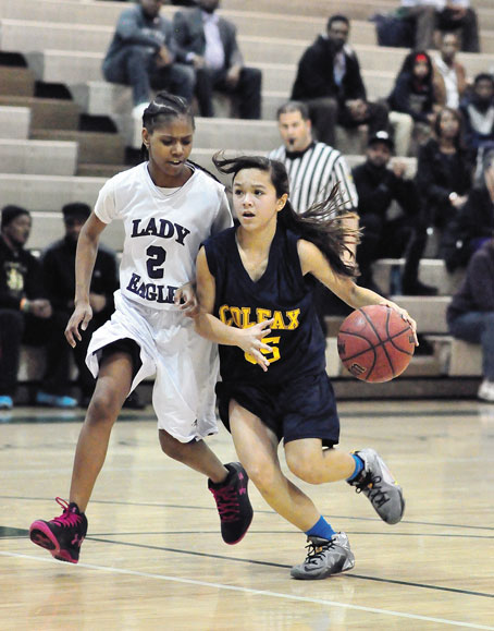 EMMA WAITE (35) of Colfax drives the lane against Aaliyah Davis of Obama Academy. Waite scored 16 points to lead Colfax to a 40-32 overtime win. 