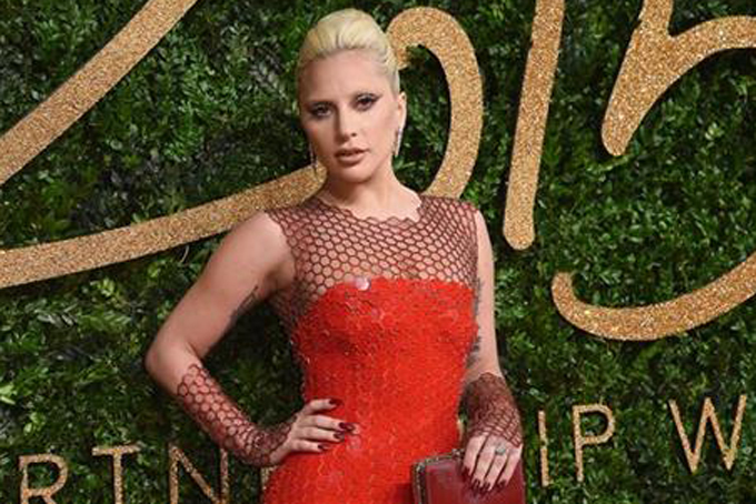 FILE - In this Nov. 23, 2015 file photo, Lady Gaga poses for photographers upon arrival at the British Fashion Awards 2015 in London. NFL said, Tuesday, Feb. 2, 2016, that Gaga will sing “The Star-Spangled Banner” at Levi’s Stadium in Santa Clara, Calif., where the Carolina Panthers will take on the Denver Broncos. (Photo by Jonathan Short/Invision/AP, File)