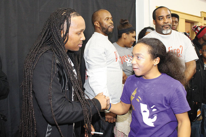 GREETING HIS FANS—Macedonia Baptist Church of Pittsburgh, located at 2225 Bedford Ave., in the Hill District, hosted its Teen Bash 2016. The theme was “G.O.T. F.I.R.E. (God Over Thoughts Feelings Image Relationships Everything)?” The featured guest was Uncle Reece, along with many other artists. There were also competitions and giveaways. Pictured above, Uncle Reece is shaking hands with his 14-year-old fan, Khalil Schaeffer. See more photos on B-8. (Photos by J. L. Martello)