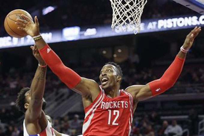 In this Nov. 30. 2015, file photo, Houston Rockets center Dwight Howard (12) and Detroit Pistons center Andre Drummond reach for the rebound during the first half of an NBA basketball game, in Auburn Hills, Mich. (AP Photo/Carlos Osorio, File)