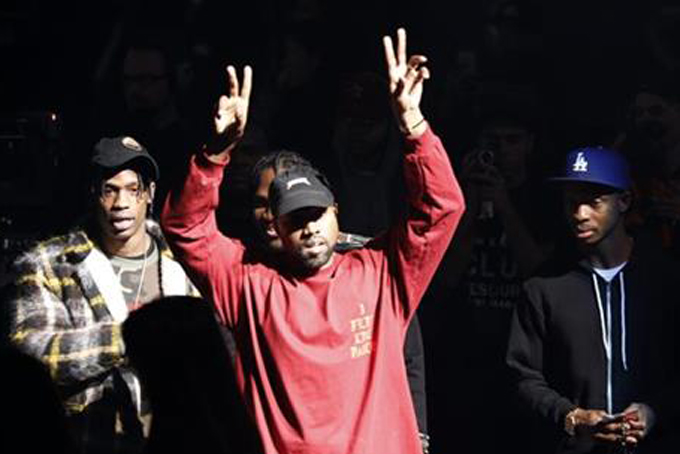 Kanye West gestures to the audience at the unveiling of the Yeezy collection and album release for his latest album, "The Life of Pablo," Thursday, Feb. 11, 2016 at Madison Square Garden in New York. (AP Photo/Bruce Barton)