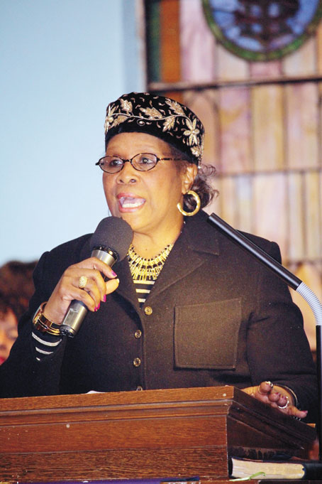 REV. MARIE KELLY giving the offering prayer. 