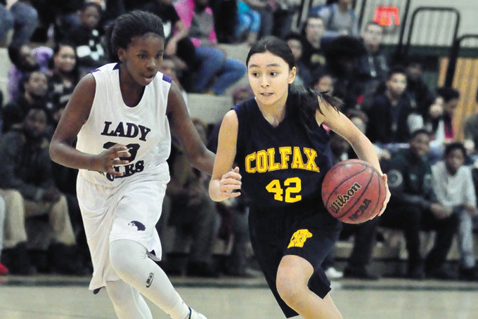 SOFIA NORTH (42) of Colfax drives on Alya Sledge of Obama Academy in the middle school championship game. North scored 15 points to help Colfax to the 40-32 overtime win. 